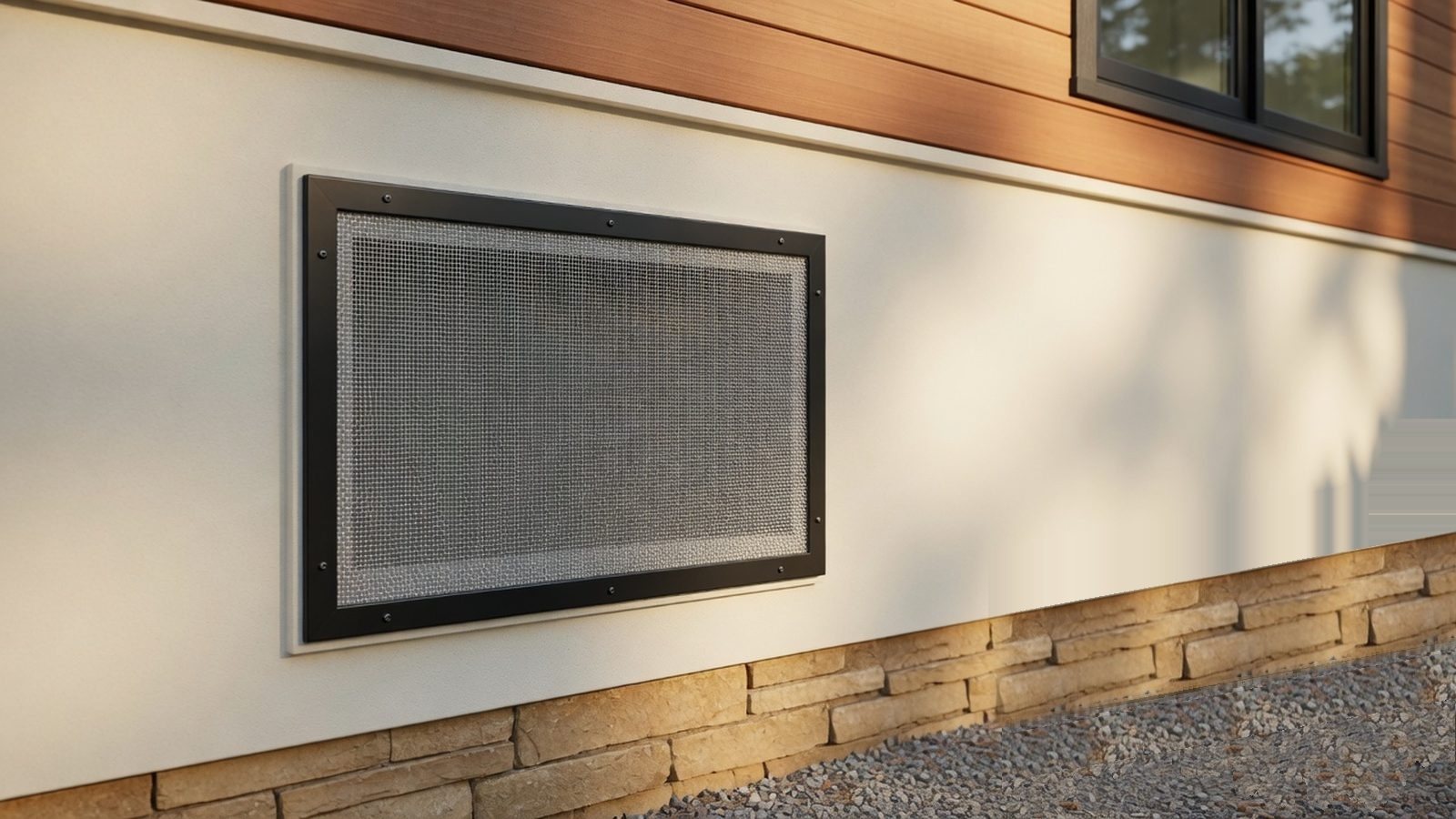 An ember-resistant wall vent with fine metal mesh set into the stucco wall of a mountain home